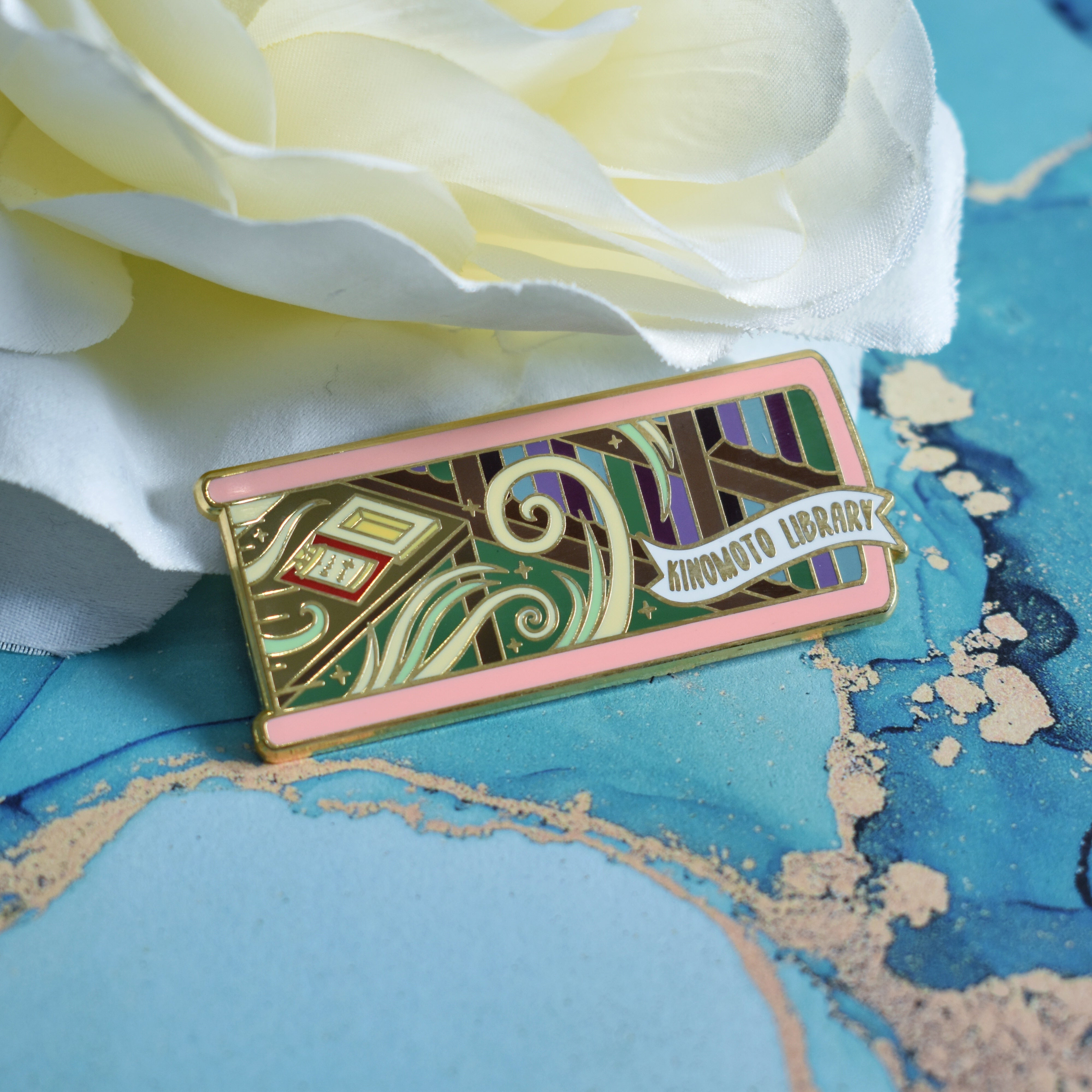 The Kinomoto Library inspired enamel pin featuring Cardcaptor Sakura.