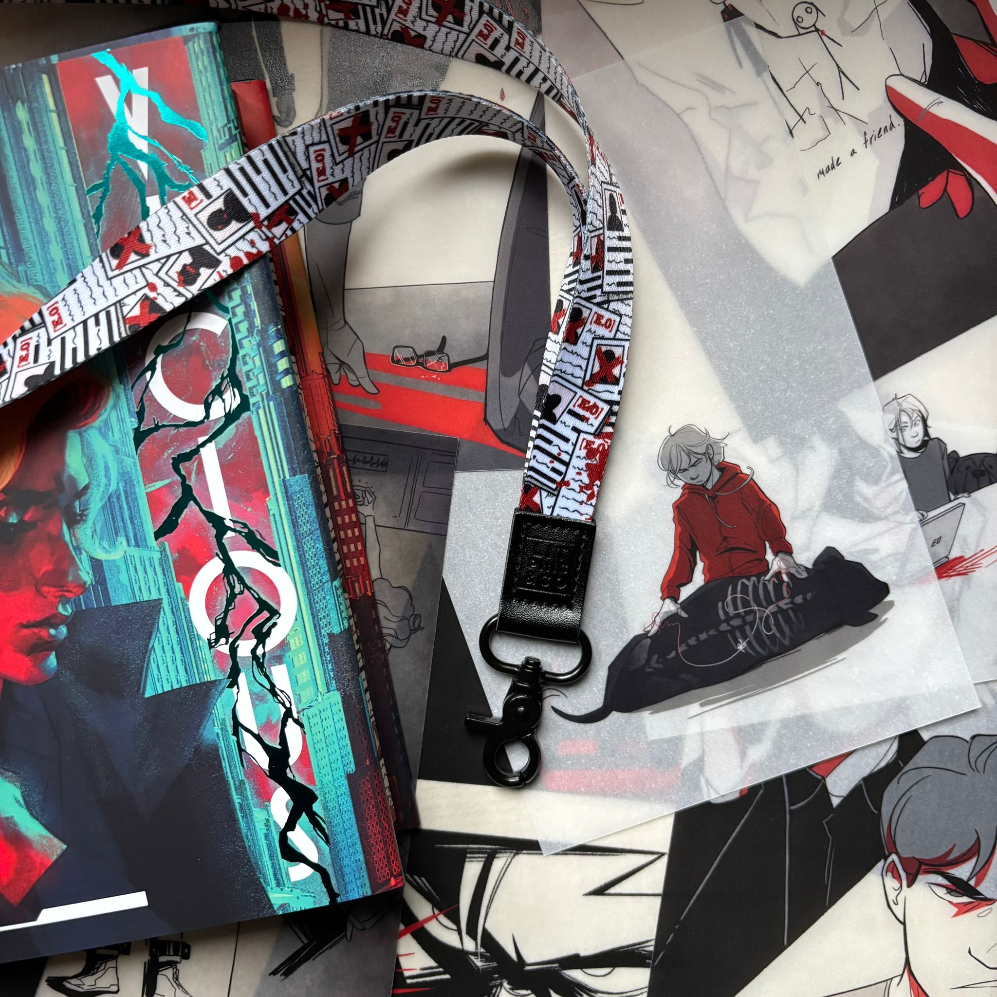 LitPins&Co's Vicious by V/E Schwab Collector's lanyard, featuring a design of Eli's E.O files with blood splatters resting against a copy of the book and page overlays scattered in the background.