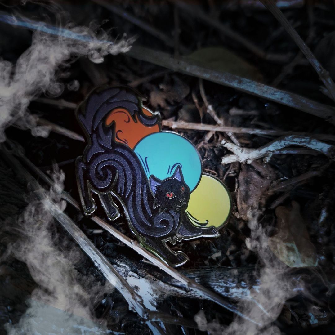 Enamel pin of a black cat, inspired by Mister Kindly from Nevernight by Jay Kristoff