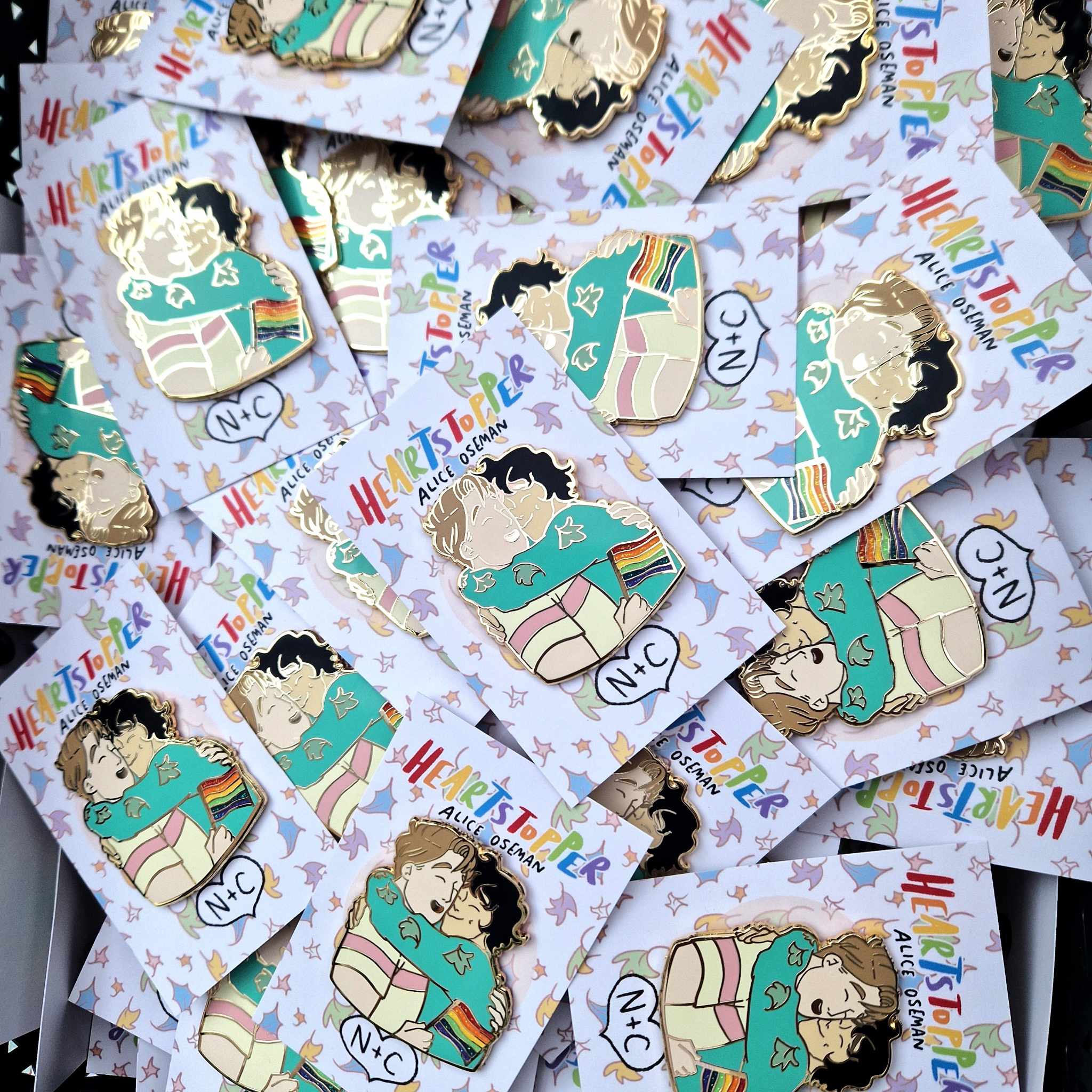 Officially licensed Heartstopper pride pins. Features Nick and Charlie in an embrace with Nick holding a Pride Flag., designed by Alice Oseman.