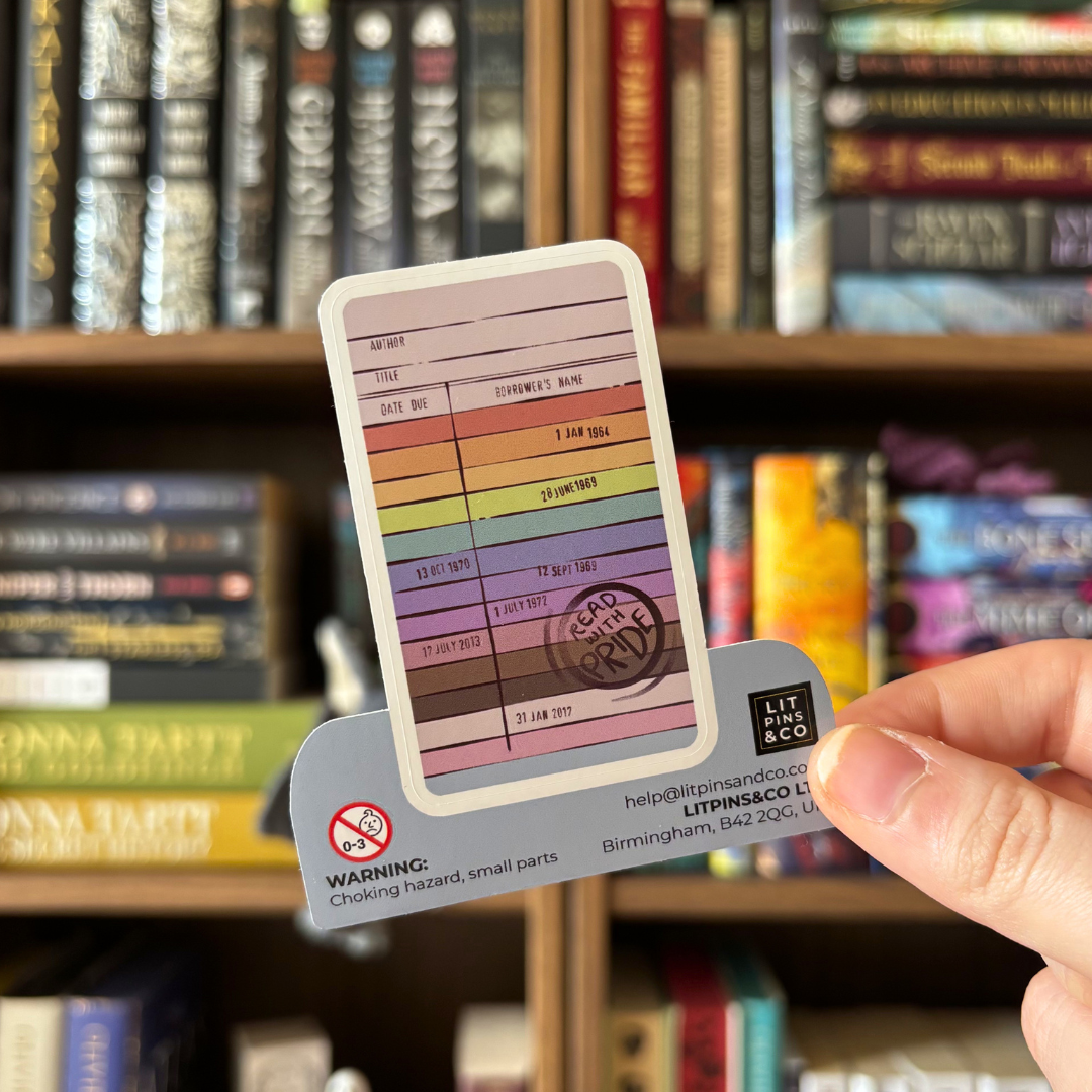 Rainbow coloured library card sticker with text and a 'Read with Pride' stamp