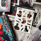 LitPins&Co Vicious 10th Anniversary Sticker Pack sheet resting against the overlays and Vicious books by VE Schwab. The stickers include Victor Vale, Eli Ever, Sidney, Mitch, Dol along with Victor's  Black out markings.