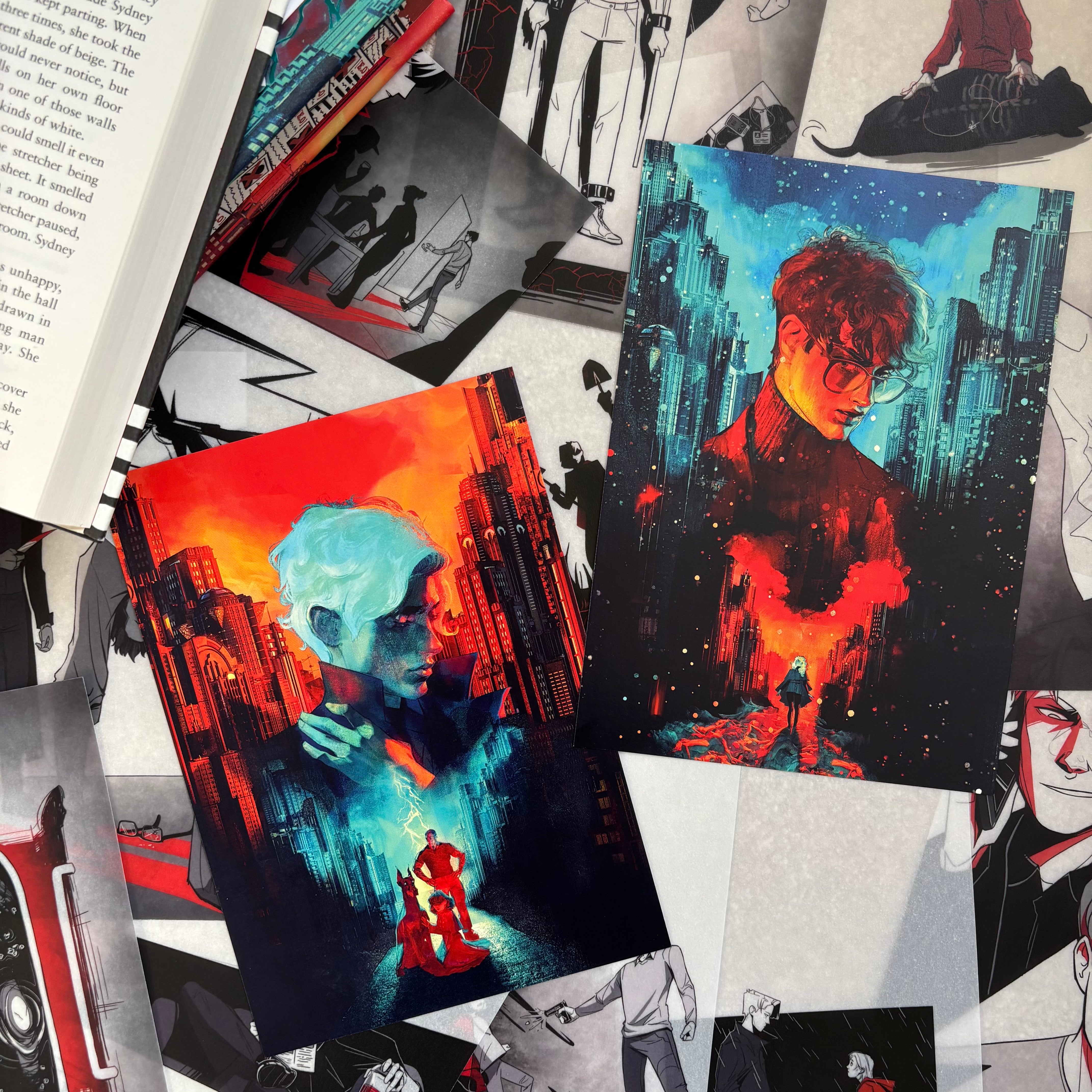 The LitPins&Co Vicious Prints featuring Victor Vale and Eli Ever lying against the backdrop of the page overlays from the collector's edition book for the ten-year anniversary of Vicious by VE Schwab.