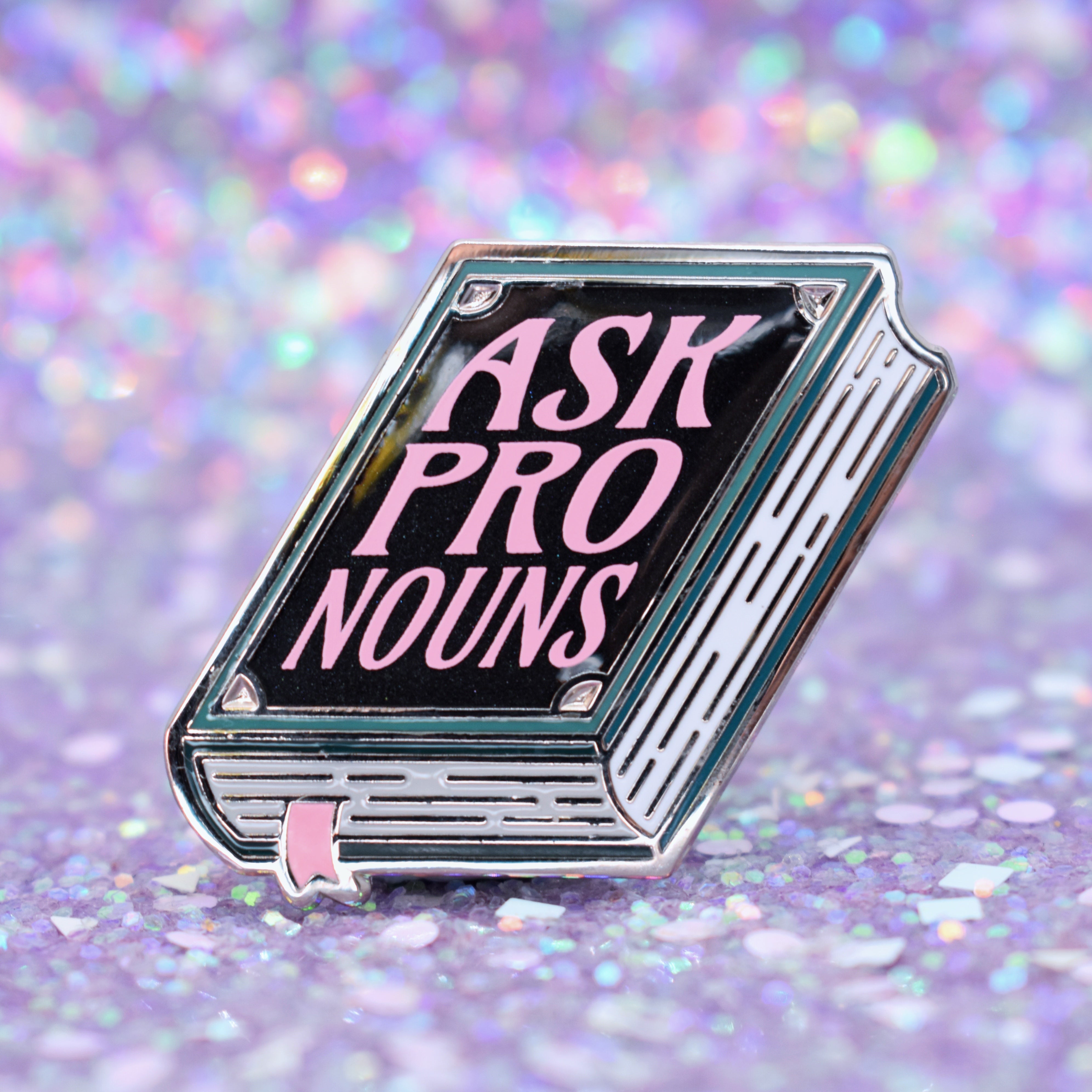 Book shaped pronoun pin on a decorative background
