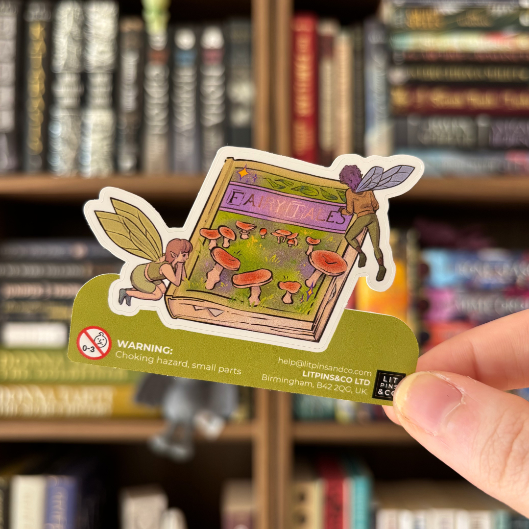 Book shaped sticker inspired by fairytales, featuring two fairies and mushrooms on a closed book.