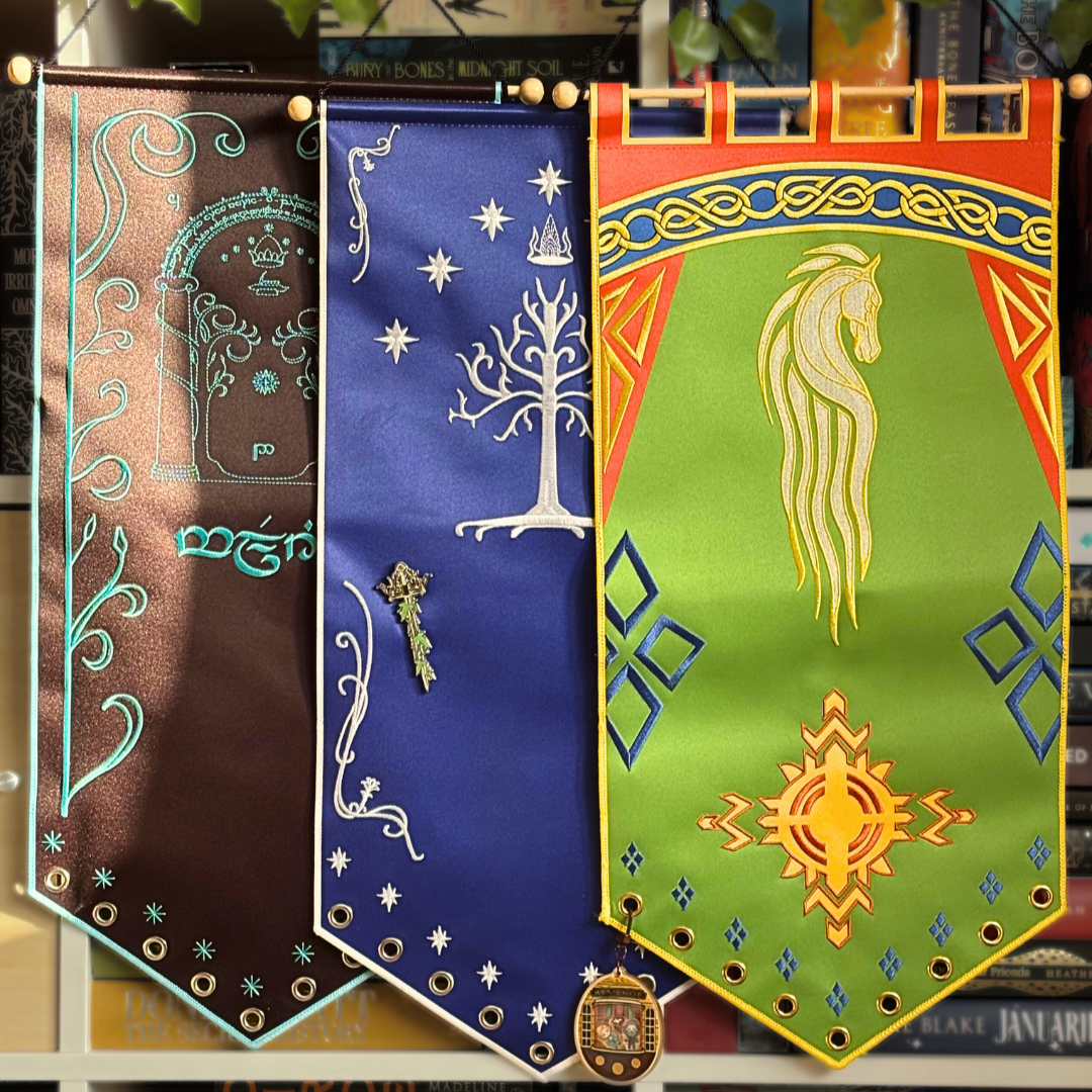 Lord of the Rings inspired pin banners, displayed against a bookshelf