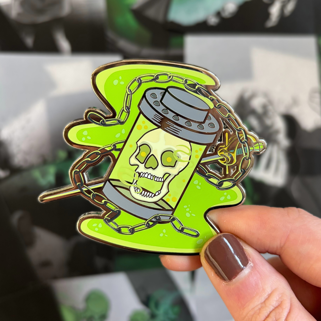 Enamel pin featuring the Skull from Lockwood&Co by Jonathan Stroud, held against a blurred background of page overlays.
