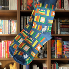 Blue socks decorated with cats and books