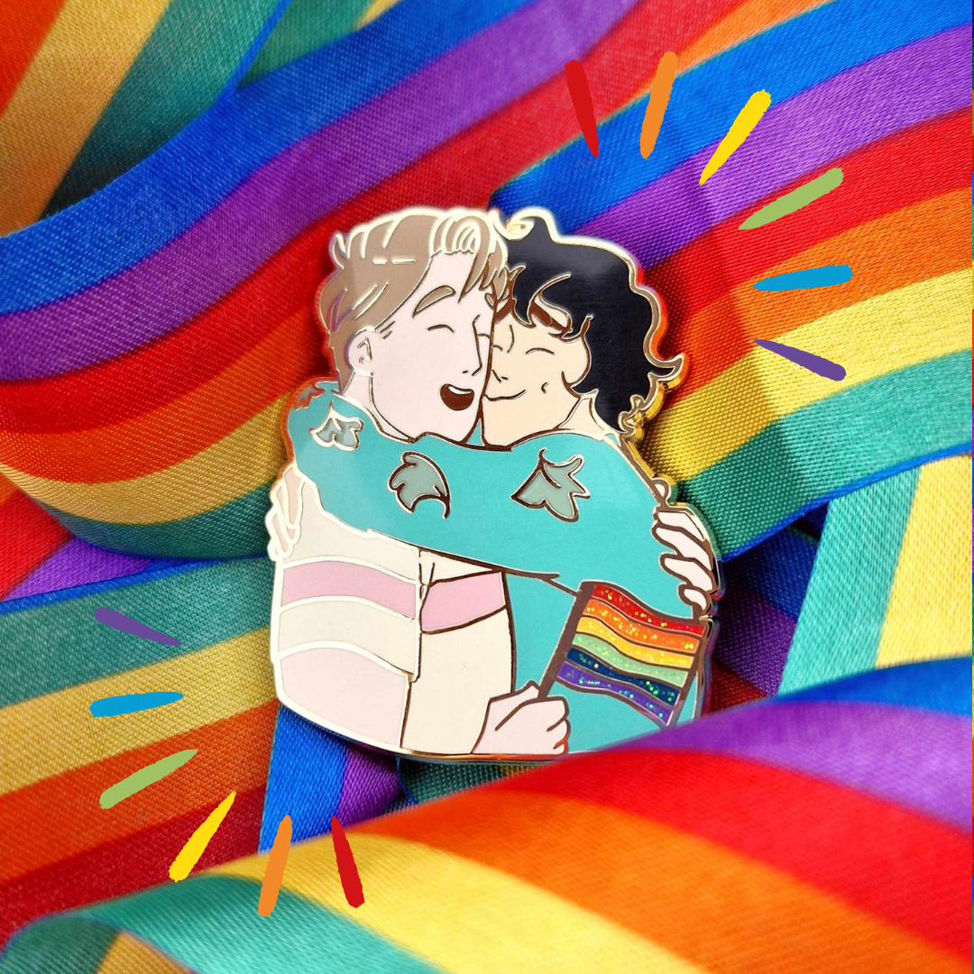 Heartstopper Nick and Charlie Pride Enamel Pin featuring Nick and Charlie in an embrace with Nick holding a Pride Flag.