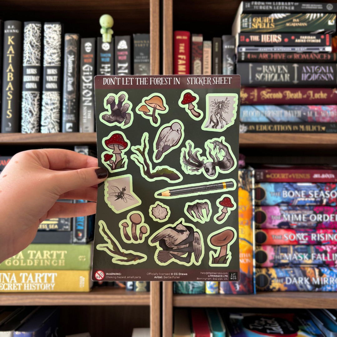 A sticker sheet featuring various woodland illustrations including mushrooms, a bird, a beetle, and tree roots, presented on a dark green background. Sticker sheet is pictured on a black graphic with a yellow and white border.