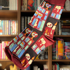 Burgundy socks featuring a dark academia inspired book pattern