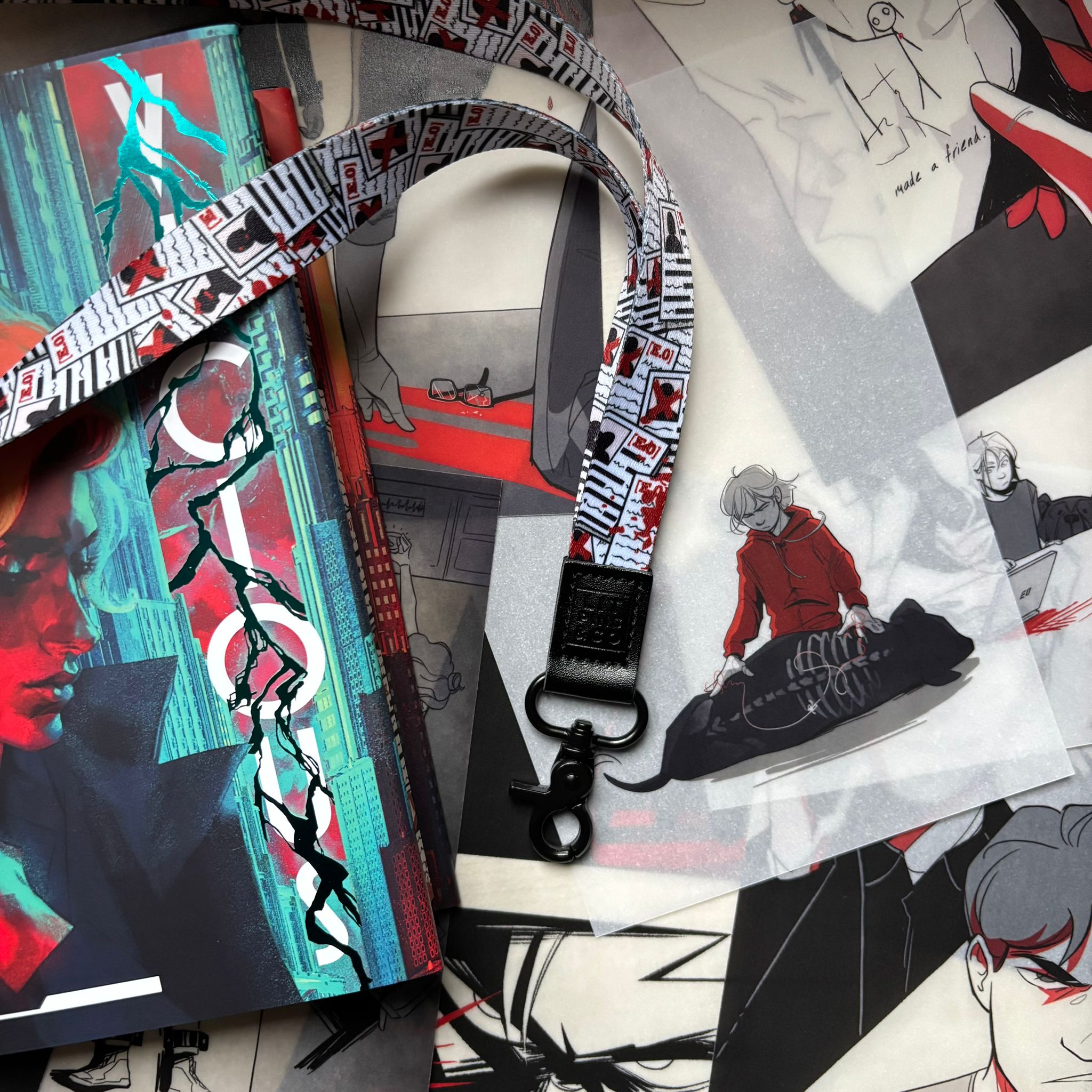 LitPins&Co's Vicious by V/E Schwab Collector's lanyard, featuring a design of Eli's E.O files with blood splatters resting against a copy of the book and page overlays scattered in the background. 