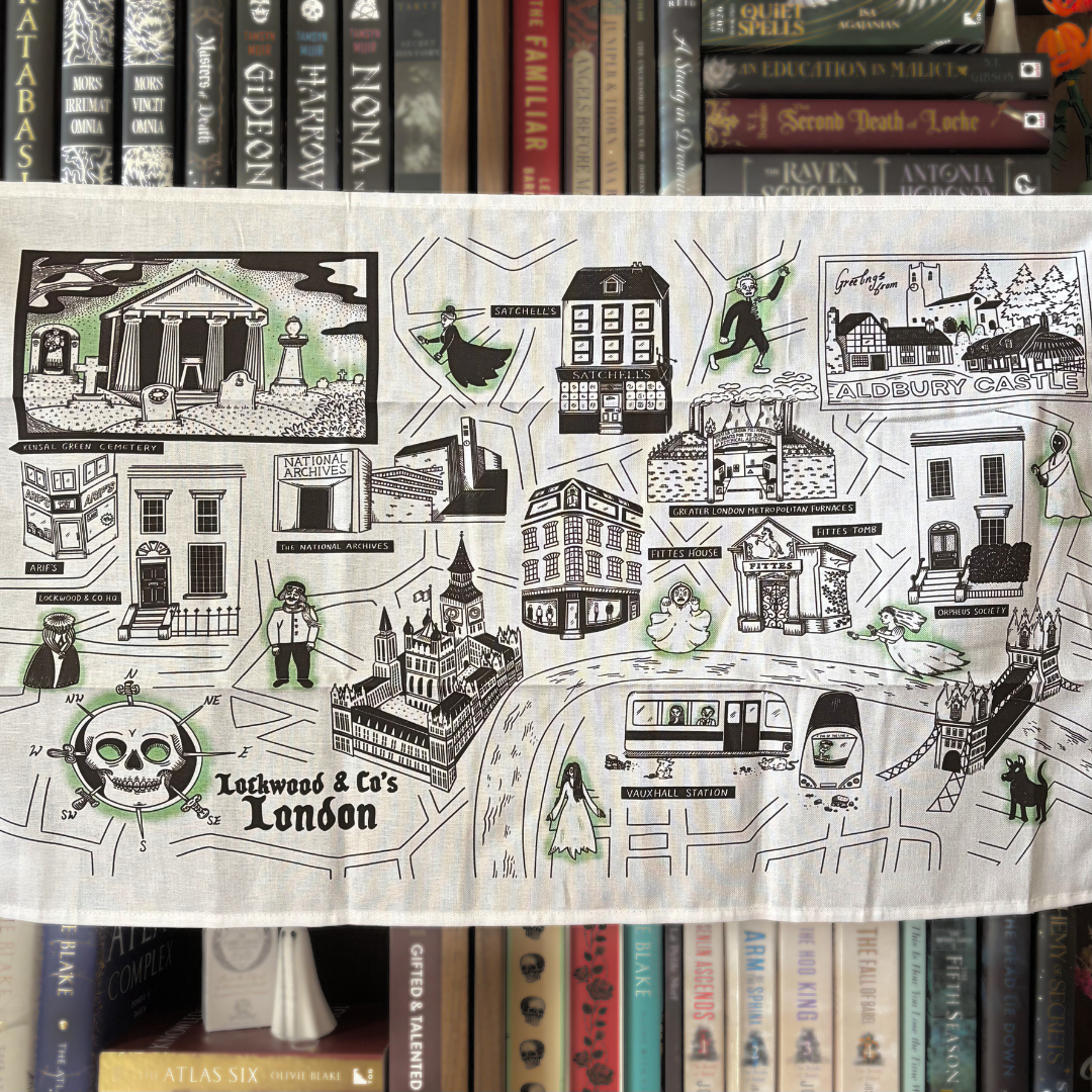 A white tea towel featuring a design of "Lockwood & Co's London," showing landmarks from the series and ghosts.
