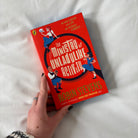 Book titled 'The Ministry of Unladylike Activity' held against a white surface