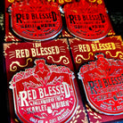 Red enamel pins reading "red blessed follower of the scarlet maiden, cult-ish, cult-adjacent," inspired by Painted Devils by Margaret Owen