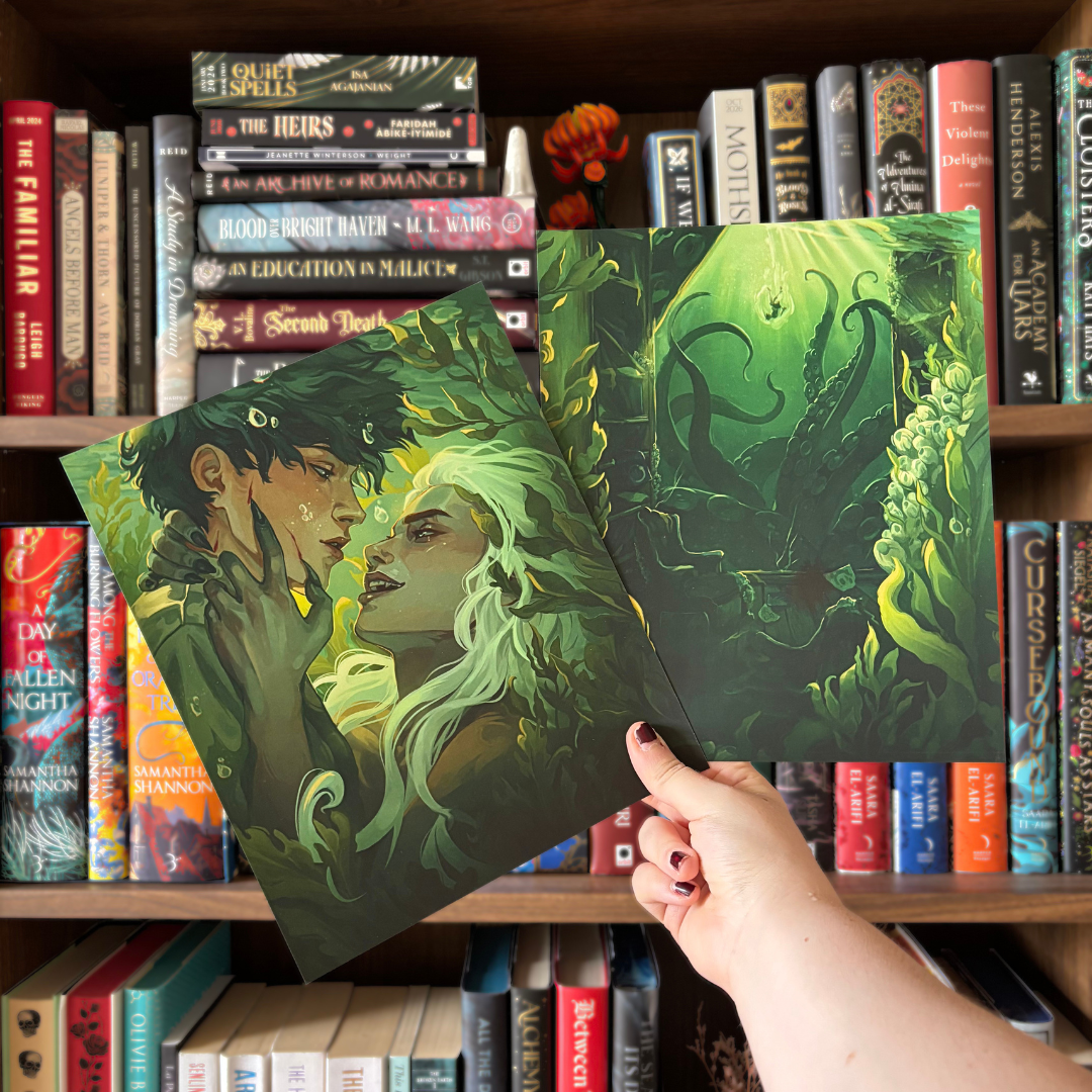Two green art prints featuring the cover artwork of the LitPins&Co special edition of Scorpion Deep by CG Drews, held in front of a bookshelf