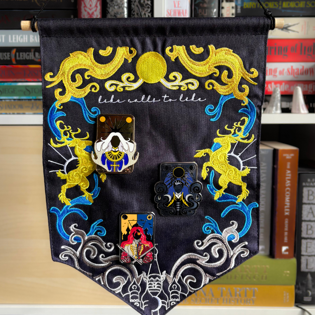 Pin banner inspired by Shadow and Bone, decorated with sun and moon themed embroidery and the quote "Like calls to like"