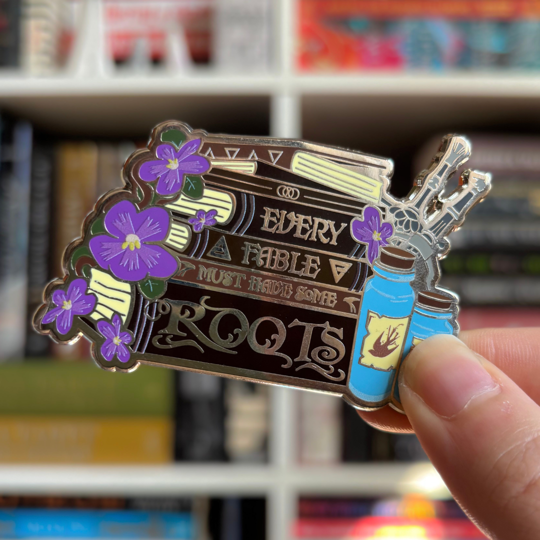 The Witcher inspired Story Stack enamel pin featuring the quote Every Fable Must Have Some Roots.