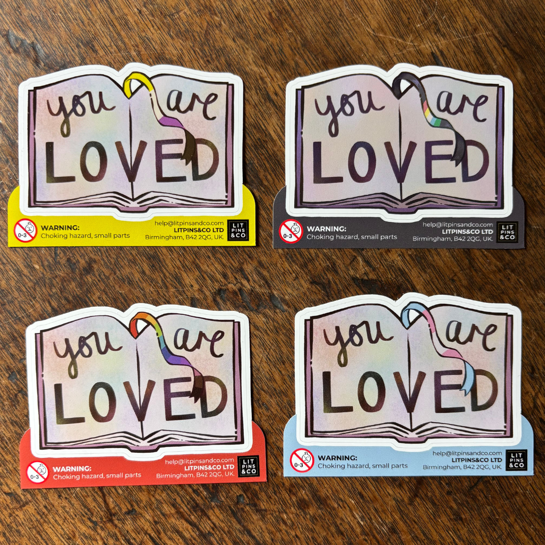 Book-shaped stickers with the text "you are LOVED" decorated in colours of various pride flags