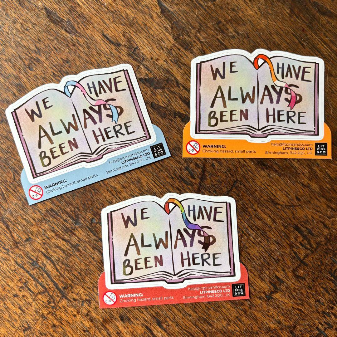 Book-shaped stickers with the text "We have always been here" decorated in colours of various pride flags