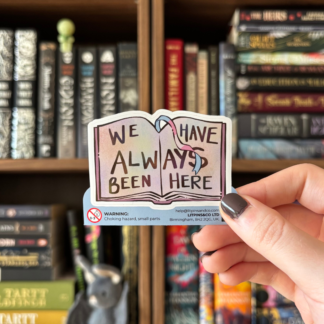 Book-shaped stickers with the text "We have always been here" decorated in colours of various pride flags