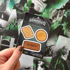 Hand holding a 'Lockwood & Co' mini biscuit sticker set 