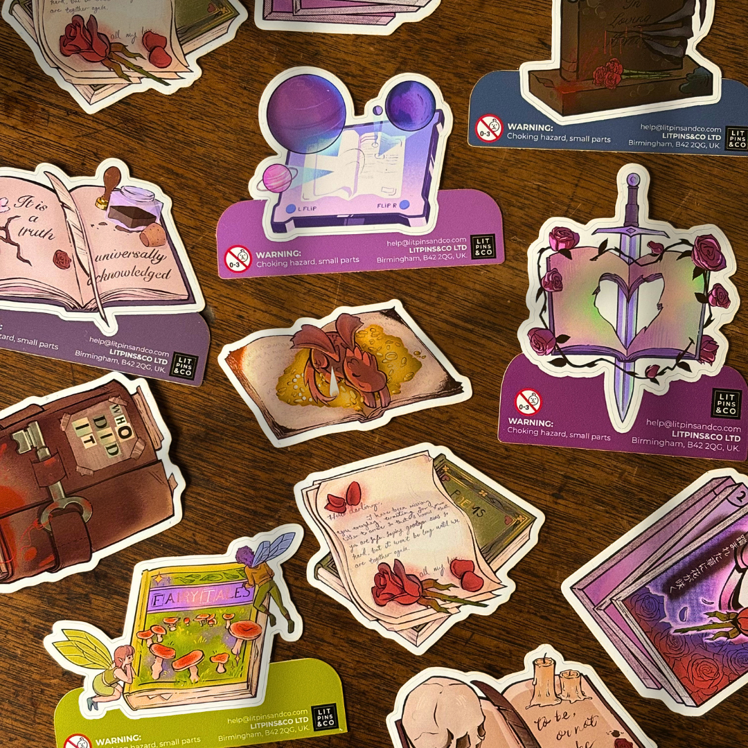 A selection of book shaped stickers themed around various genres, pictured on a wooden background.