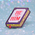 Book shaped pronoun pin on a decorative background 