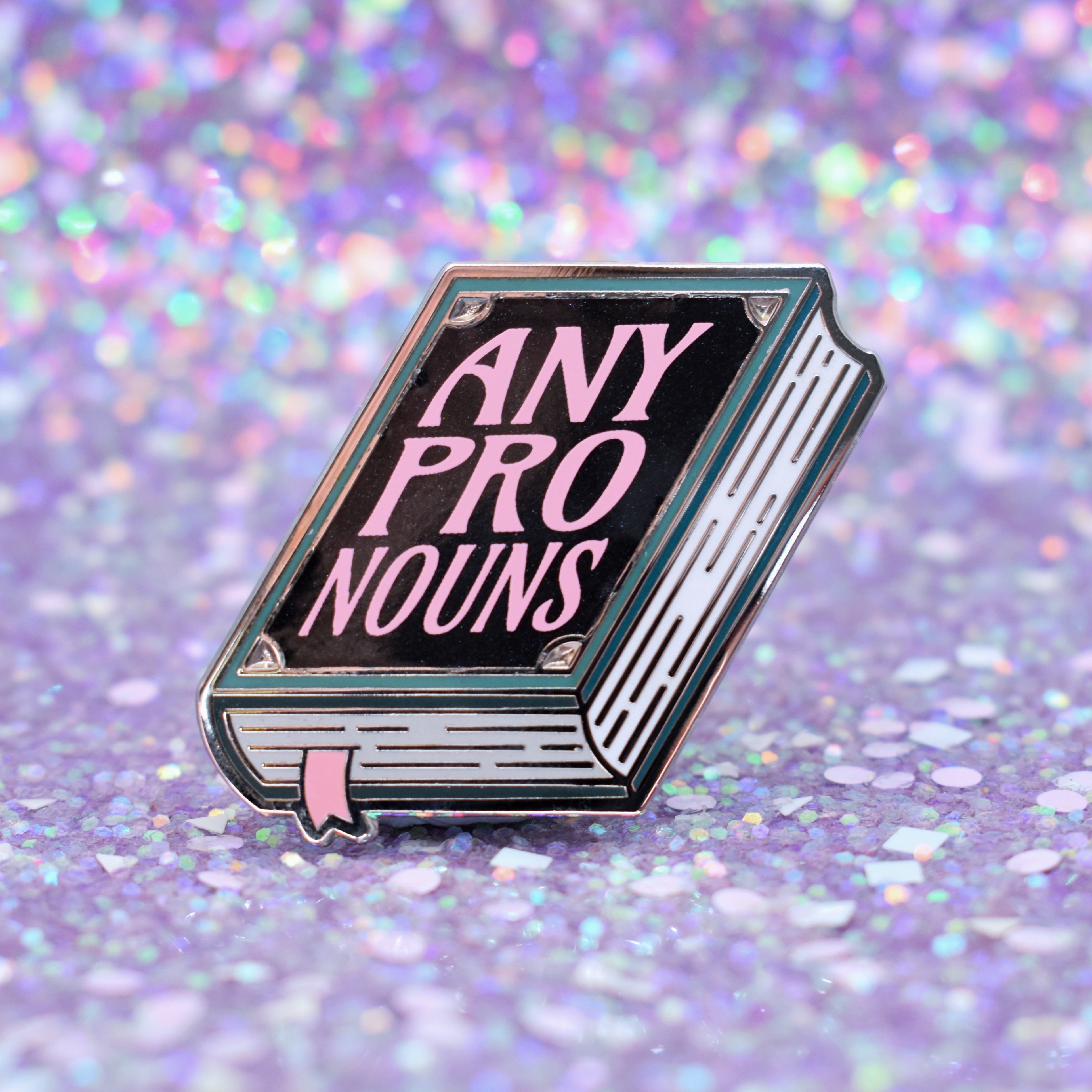 Book shaped pronoun pin on a decorative background 