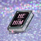 Book shaped pronoun pin on a decorative background 