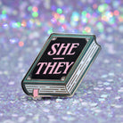 Book shaped pronoun pin on a decorative background 