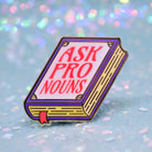 Book shaped pronoun pin on a decorative background 