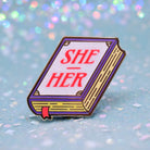 Book shaped pronoun pin on a decorative background 