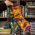 orange and green socks with a book pattern