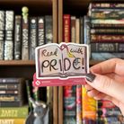 Book-shaped sticker with the text "Read with pride" decorated in colours of various pride flags