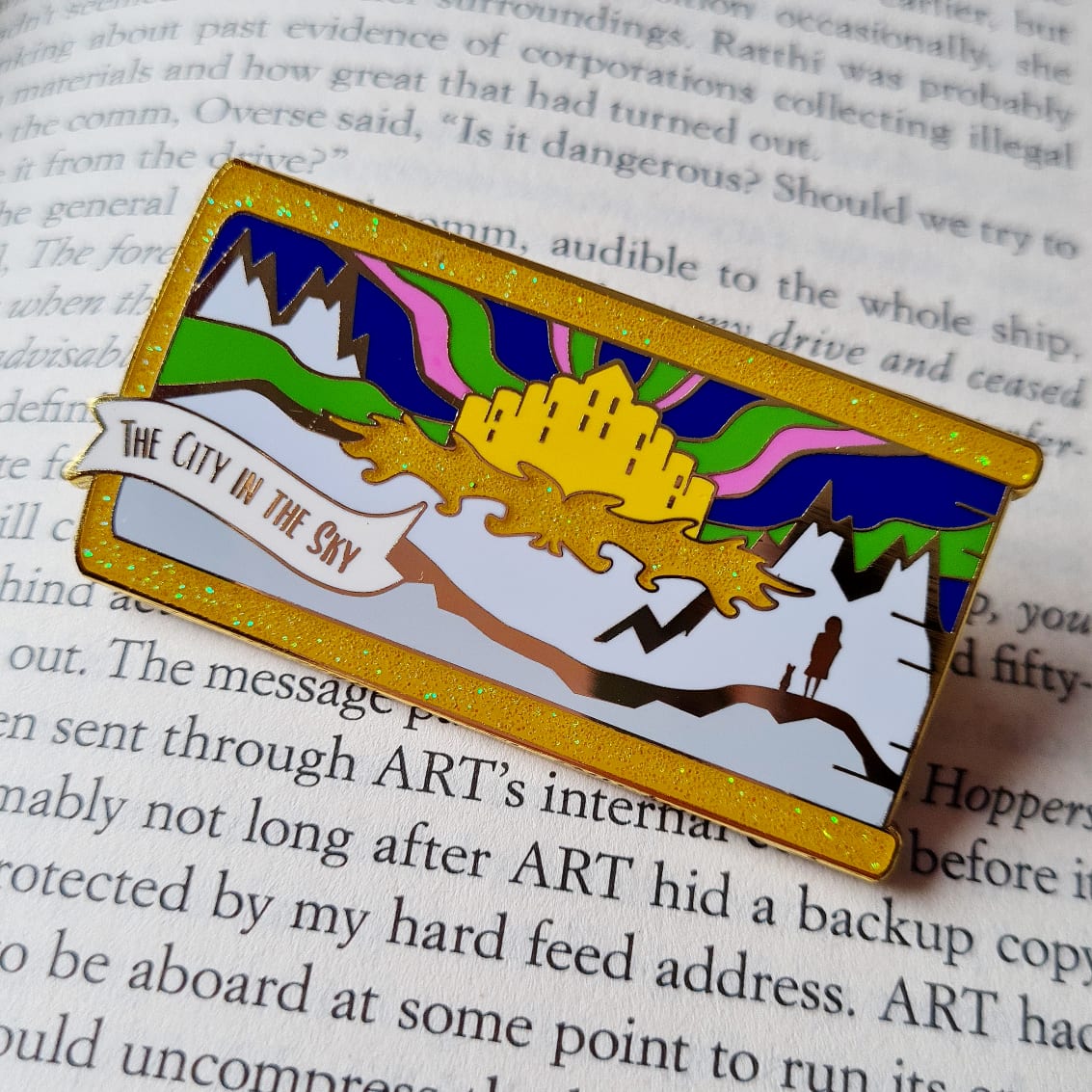 The City in the Sky build your own book stack enamel pin inspired by Philip Pullman's His Dark Materials series.