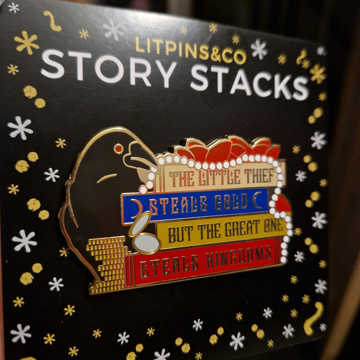 &quot;The Little Thief Steals Gold But The Great One Steals Kingdoms.&quot; Enamel pin inspired by Marget Owen on a LitPins&amp;Co Story Stack backing card.