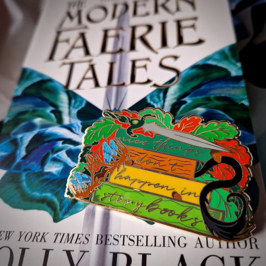 The Cruel Prince by Holly Black Story Stack Enamel Pin sitting ontop of The Modern Faerie Tales by Holly Black