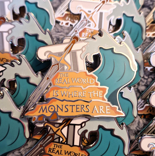 Percy Jackson story stack inspired enamel pin featuring the quote The Real World Is Where The Monsters Are.
