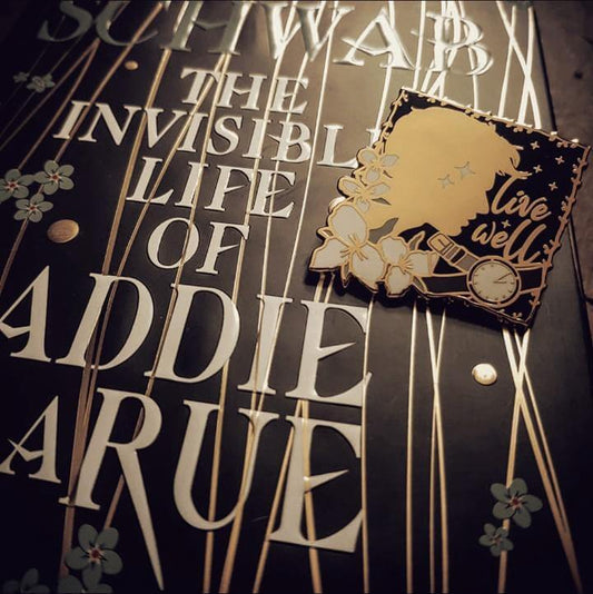 Live Well enamel pin inspired by The Invisible Life of Addie LaRue by V.E Schwab.
